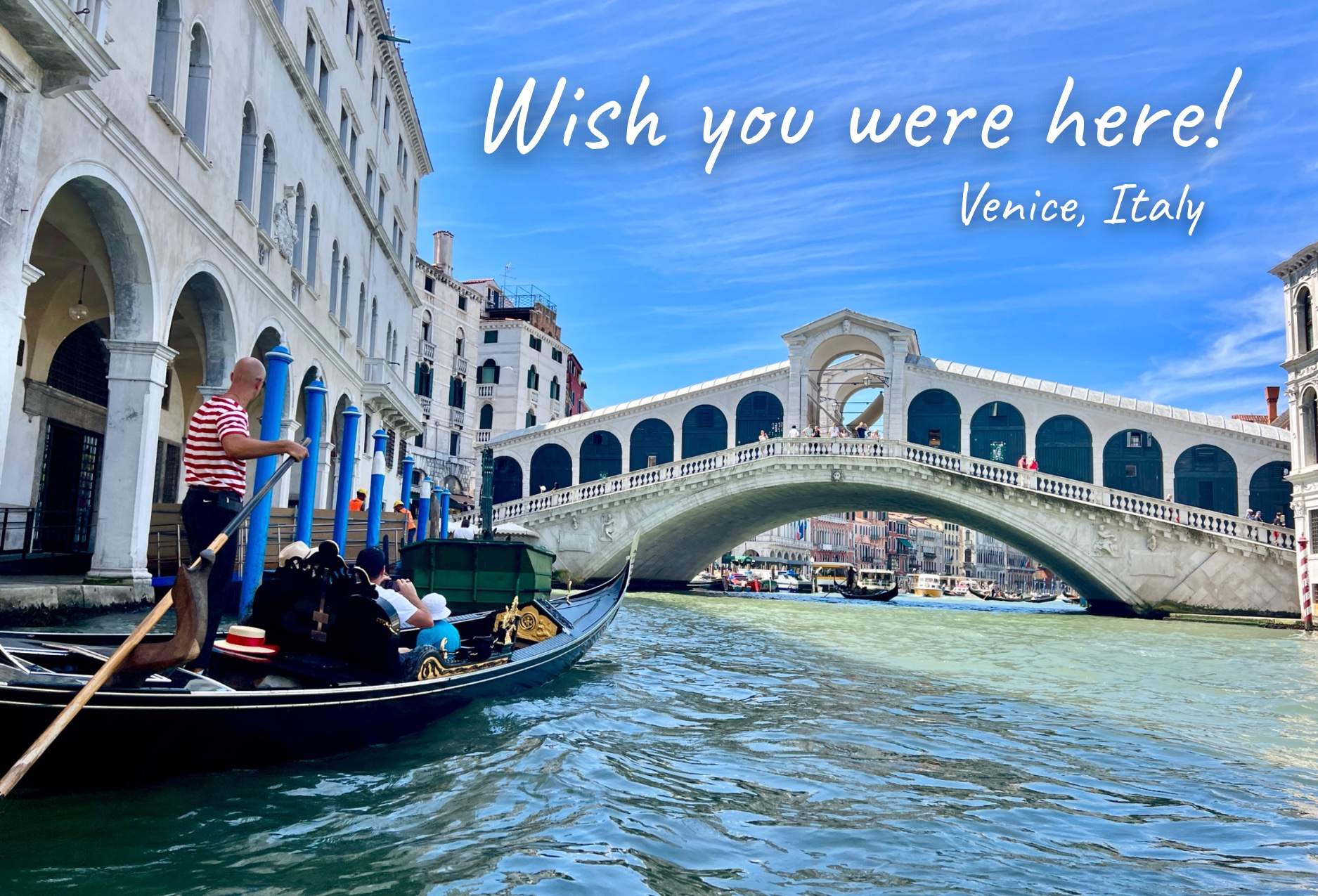 The front of a printed SnapACard postcard: a Venice canal with the caption Wish you were here!